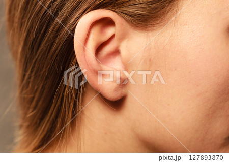 Close up on female ear 127893870