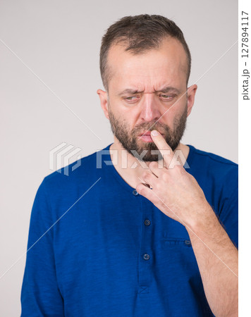 Confused focused serious man thinking Confused focused serious man thinking 127894117