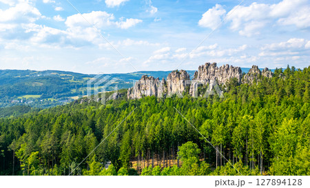 Discover the stunning dry rocks of Suche skaly in Bohemian Paradise, Czechia. This sandstone formation showcases nature's beauty amid lush greenery and blue skies. 127894128
