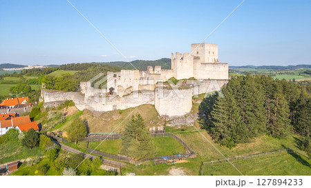 Rabi Castle ruins stand majestically against the backdrop of Czech countryside. This drone view showcases the historical structure surrounded by lush greenery and distant hills on a clear day. Rabi Castle ruins stand majestically against the backdrop of Czech countryside. This drone view showcases the historical structure surrounded by lush greenery and distant hills on a clear day. 127894233
