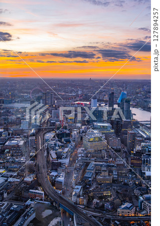 Spectacular sunset envelops London from The Shard, casting vibrant colors over the skyline, bustling streets, and iconic landmarks. A breathtaking sight showcasing the city's beauty at dusk. Spectacular sunset envelops London from The Shard, casting vibrant colors over the skyline, bustling streets, and iconic landmarks. A breathtaking sight showcasing the city's beauty at dusk. 127894257