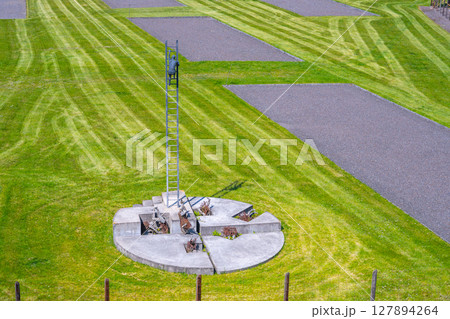 A memorial dedicated to the victims of communism stands in the former prison complex in Lesetice, Czechia. The well-kept grounds feature cut grass and orderly pathways, symbolizing remembrance. A memorial dedicated to the victims of communism stands in the former prison complex in Lesetice, Czechia. The well-kept grounds feature cut grass and orderly pathways, symbolizing remembrance. 127894264