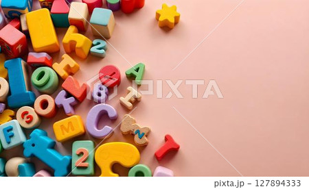 A lively mix of toy blocks on a pink surface, embodying a playful atmosphere for preschool and kindergarten A lively mix of toy blocks on a pink surface, embodying a playful atmosphere for preschool and kindergarten 127894333