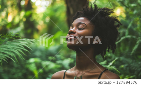 Young Black Woman Enjoying Nature in a Forest 127894376