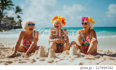 Joyful senior women laughing on a tropical beach Joyful senior women laughing on a tropical beach 127894382