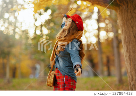 happy stylish woman in jeans shirt and hat rejoicing happy stylish woman in jeans shirt and hat rejoicing 127894418