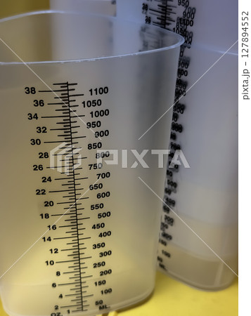 Close-Up of Graduated Plastic Measuring Cylinders in Healthcare Setting 127894552