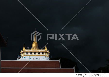 Golden mountain in Wat Saket Bangkok Thailand covered with dark rain clouds at the top looks scary before the rain falls. 127894638