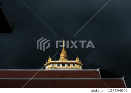 Golden mountain in Wat Saket Bangkok Thailand covered with dark rain clouds at the top looks scary before the rain falls. 127894641