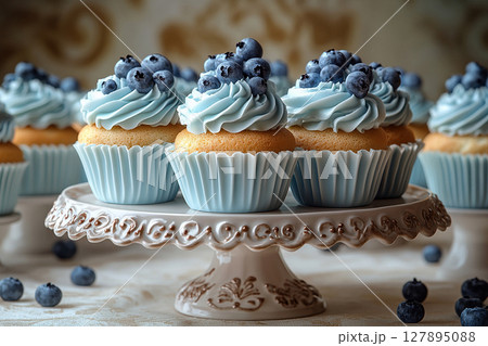Various cakes in blue tones on dessert stand with soft lighting. Various cakes in blue tones on dessert stand with soft lighting. 127895088