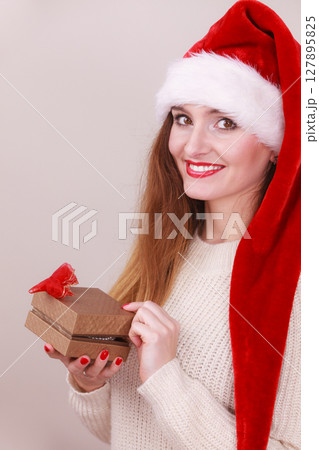 Woman opening gift box. Christmas time Woman opening gift box. Christmas time 127895825
