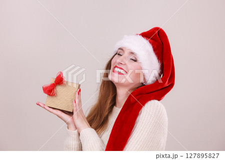Christmas girl with small gift. 127895827
