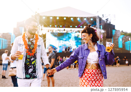 Group of friends with beer dancing and having fun at music festival together. Summer Beach party. Group of friends with beer dancing and having fun at music festival together. Summer Beach party. 127895954