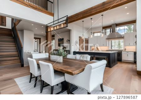 Modern open plan interior design showcasing rustic dining table and kitchen 127896587