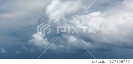 A serene panoramic view of white fluffy clouds stretching across a clear blue sky A serene panoramic view of white fluffy clouds stretching across a clear blue sky 127896776