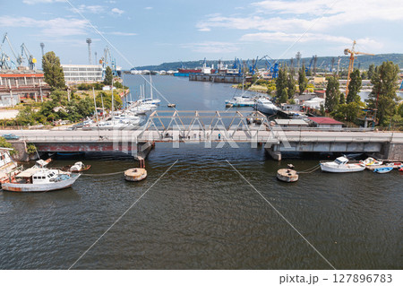 A vibrant industrial port area featuring an old bridge over Varna lake A vibrant industrial port area featuring an old bridge over Varna lake 127896783