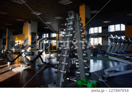 Rack with dumbbells of different weights at sport gym center Rack with dumbbells of different weights at sport gym center 127897058