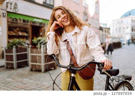 Portrait of beautiful young woman enjoying time on bicycle. Active lifestyle. Eco transport. 127897859