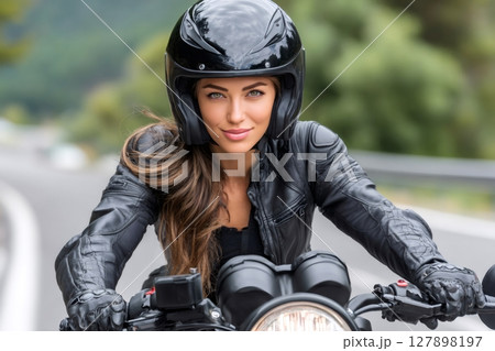Biker riding modern motorcycle on country road 127898197