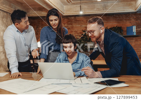 A Collaborative Office Meeting with the Entire Team Discussing the Ongoing Project Efficiently A Collaborative Office Meeting with the Entire Team Discussing the Ongoing Project Efficiently 127899453