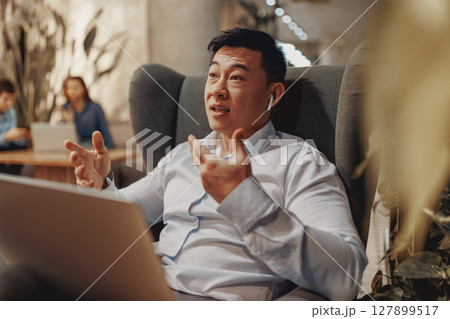A Businessman Actively Engaging in Various Forms of Online Communication and Interaction A Businessman Actively Engaging in Various Forms of Online Communication and Interaction 127899517
