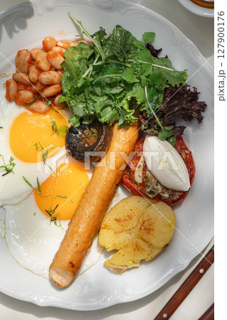 Portion of breakfast with sausage and fried eggs Portion of breakfast with sausage and fried eggs 127900176