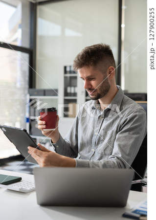 Happy man, entrepreneur, small business owner working online. Happy man, entrepreneur, small business owner working online. 127900255