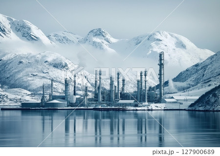 Oil refinery operates near a fjord in snowy norway, creating an industrial landscape in winter 127900689
