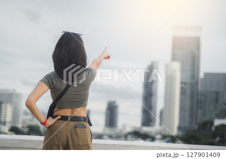 Happy young southeast asian woman solo explorer and teenager blogger on world travel. local cultural experience for asia tourism concept in Bangkok Thailand near Chao Phraya river 127901409