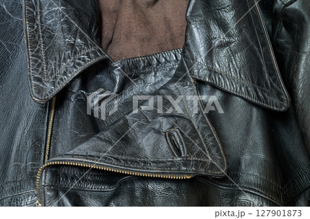 Old and aged black leather perfectoin 127901873