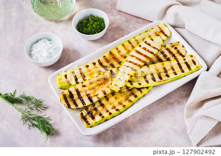 Delicious grilled vegetable zucchini on a plate on the table 127902492