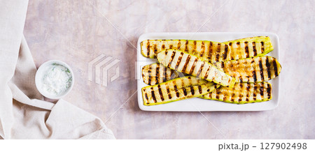 Delicious grilled vegetable zucchini on a plate on the table top view web banner 127902498