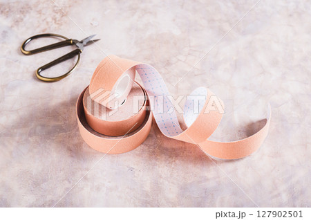 Beige special physical tapes for face and body on the table 127902501