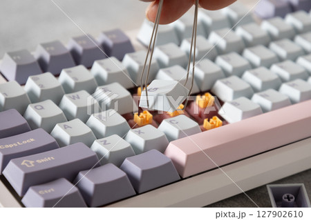 Replacement keycaps and switches of mechanical computer keyboard. Customization and build keyboard with different keycaps. Cleaning keycaps. Close up 127902610