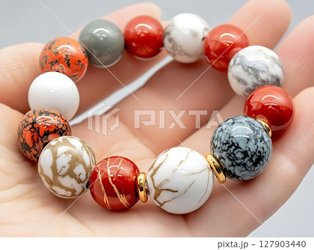 Vibrant Gemstone Bracelet Showcasing Unique Colorful Beads in Hand 127903440