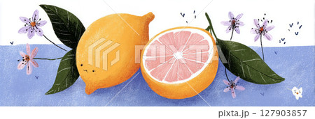Two ripe lemons, one whole and one halved, are displayed alongside delicate flowers on a blue surface. This vibrant arrangement captures the essence of freshness 127903857