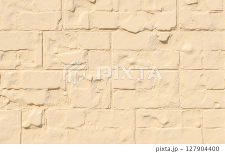 Light beige stone wall texture with rough rectangular blocks, a perfect rustic background for construction industry themes or architectural design 127904400