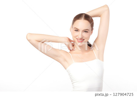 Beautiful Young woman Raises her hands to Showcase clean and hygienic underarms Against a white background, Smooth armpit cleanliness and protection concept Beautiful Young woman Raises her hands to Showcase clean and hygienic underarms Against a white background, Smooth armpit cleanliness and protection concept 127904725