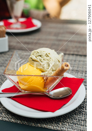 Pistachio and mango gelato in italian cafe Pistachio and mango gelato in italian cafe 127906041