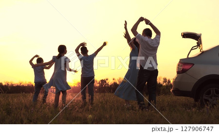 mother, father, children dancing at sunset. Happy family trip. Family car, sunset. Boy - girl dancing with dad - mom. Picnic in the open air. Brothers and sisters have fun. A childhood dream. boy mother, father, children dancing at sunset. Happy family trip. Family car, sunset. Boy - girl dancing with dad - mom. Picnic in the open air. Brothers and sisters have fun. A childhood dream. boy 127906747