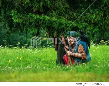 Baba Yaga with a raven on her shoulder 127907720