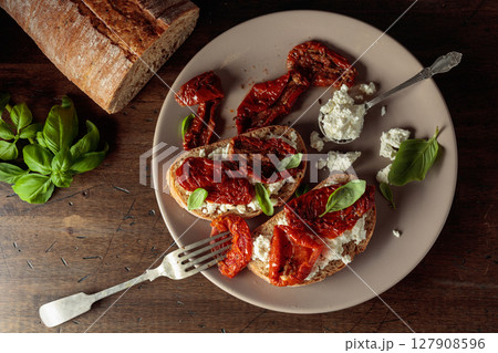 Ciabatta with sun dried tomatoes in olive oil, ricotta, and basil. Ciabatta with sun dried tomatoes in olive oil, ricotta, and basil. 127908596