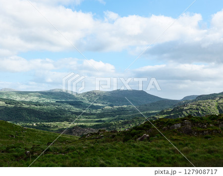 Rolling hills and verdant valleys stretch to the horizon. A postcard-perfect view of natures beauty. Rolling hills and verdant valleys stretch to the horizon. A postcard-perfect view of natures beauty. 127908717
