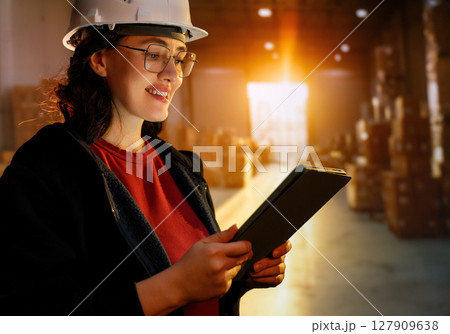 Young woman is working in warehouse Young woman is working in warehouse 127909638