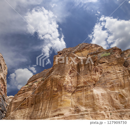 Mountains of Petra (against the background of a beautiful sky with clouds), Jordan, Middle East. Petra has been a UNESCO World Heritage Site since 1985 127909730
