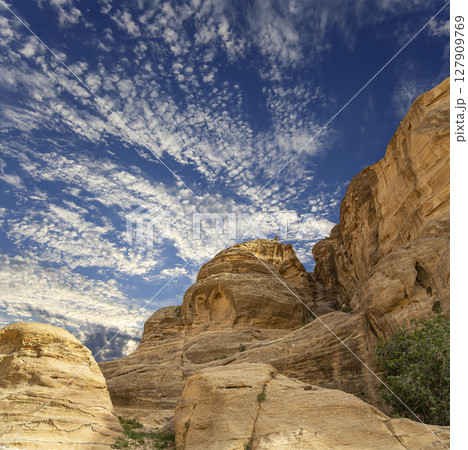 Mountains of Petra (against the background of a beautiful sky with clouds), Jordan, Middle East. Petra has been a UNESCO World Heritage Site since 1985 Mountains of Petra (against the background of a beautiful sky with clouds), Jordan, Middle East. Petra has been a UNESCO World Heritage Site since 1985 127909769