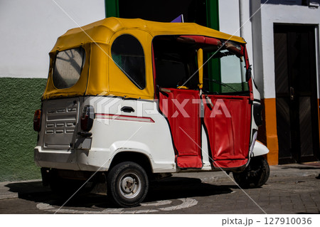 Motor tricycle at the beautiful streets of the Heritage Town of Jerico located in the Department of Antioquia in Colombia. 127910036