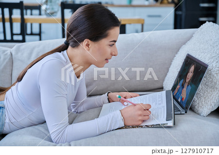 Teenage girl student having online lesson, watching webinar, at home 127910717