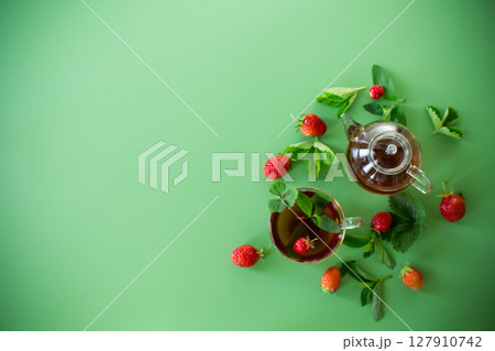 Brewed fruit tea with strawberries, minimalism and color Brewed fruit tea with strawberries, minimalism and color 127910742