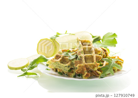 Crispy vegetable waffles served with herbs on white background Crispy vegetable waffles served with herbs on white background 127910749